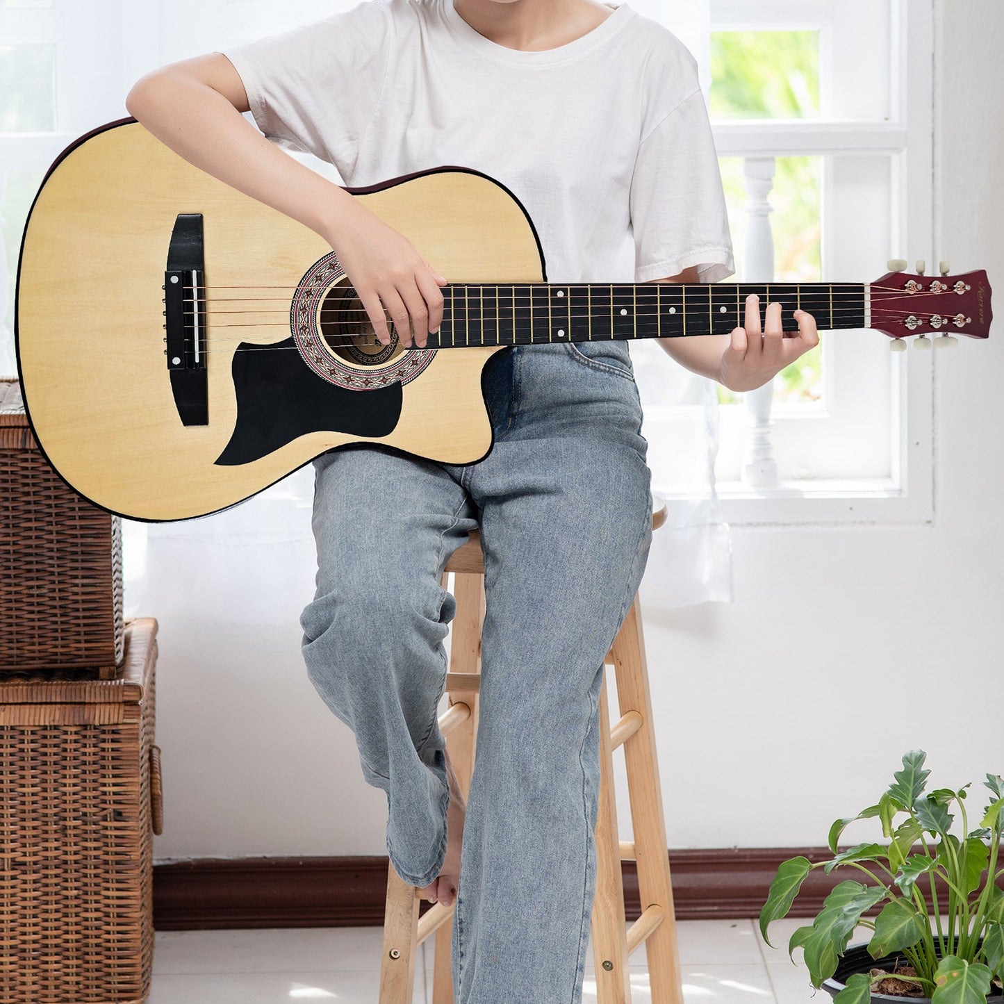 Acoustic Guitar | Karrera 38 Inch Cutaway | Steel Strings | Natural. Girl sitting on stool playing guitar.
